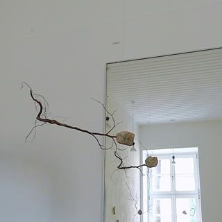 Schwebende Wesen aus Findlingen und Ästen